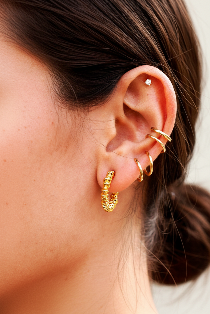 Jaden gold coil wrap spiral hoop earrings styled in ear stack