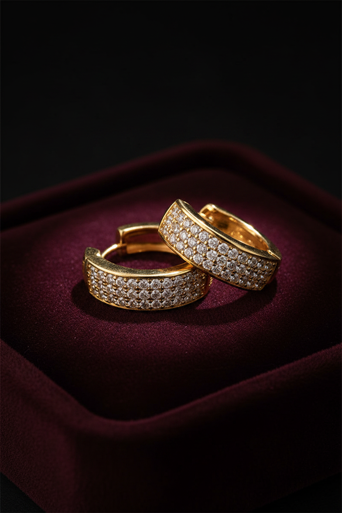 Prague gold pave diamond huggie hoop earrings on dark velvet jewelry tray