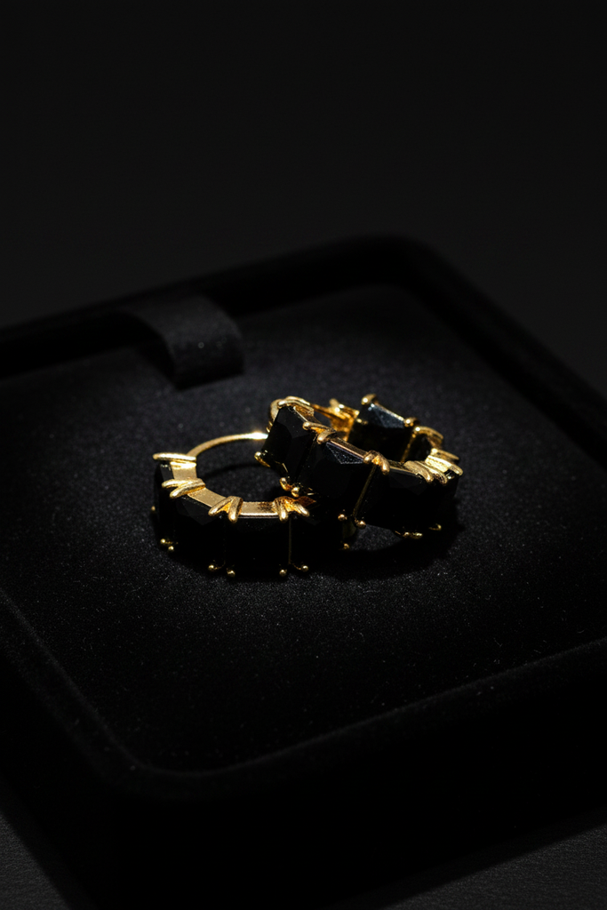 Kennedy black stone huggie hoop earrings on dark velvet tray
