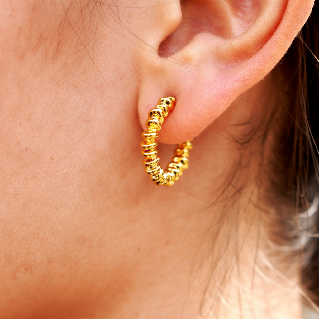 Jaden gold coil wrap spiral hoop earrings close-up texture detail