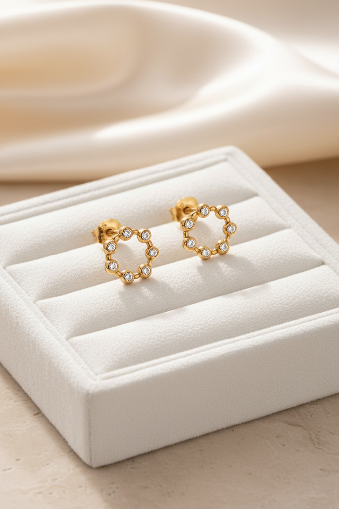 Savannah gold crystal stud earrings on white velvet jewelry tray