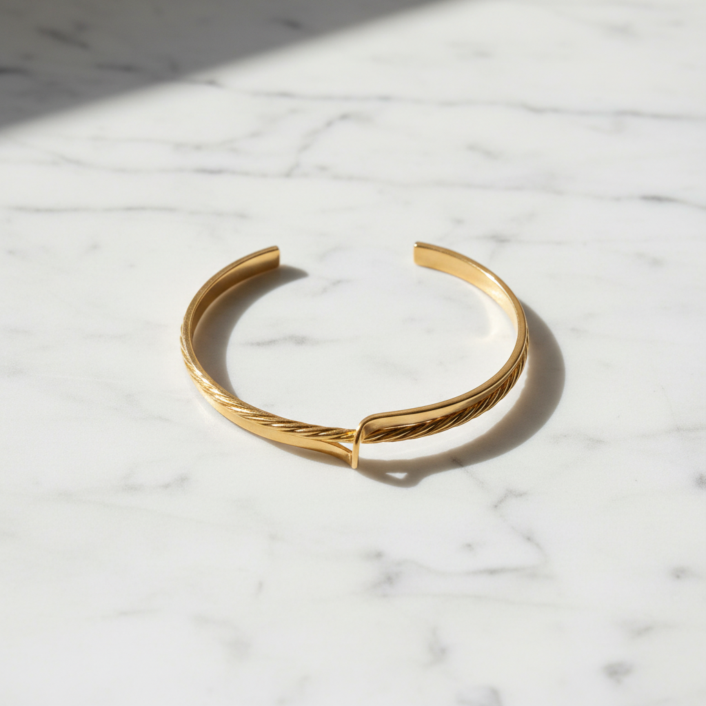McKinley dual-texture gold open cuff bracelet flat lay on white marble