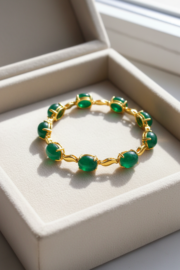 Halona cabochon emerald and gold bracelet cream velvet tray display