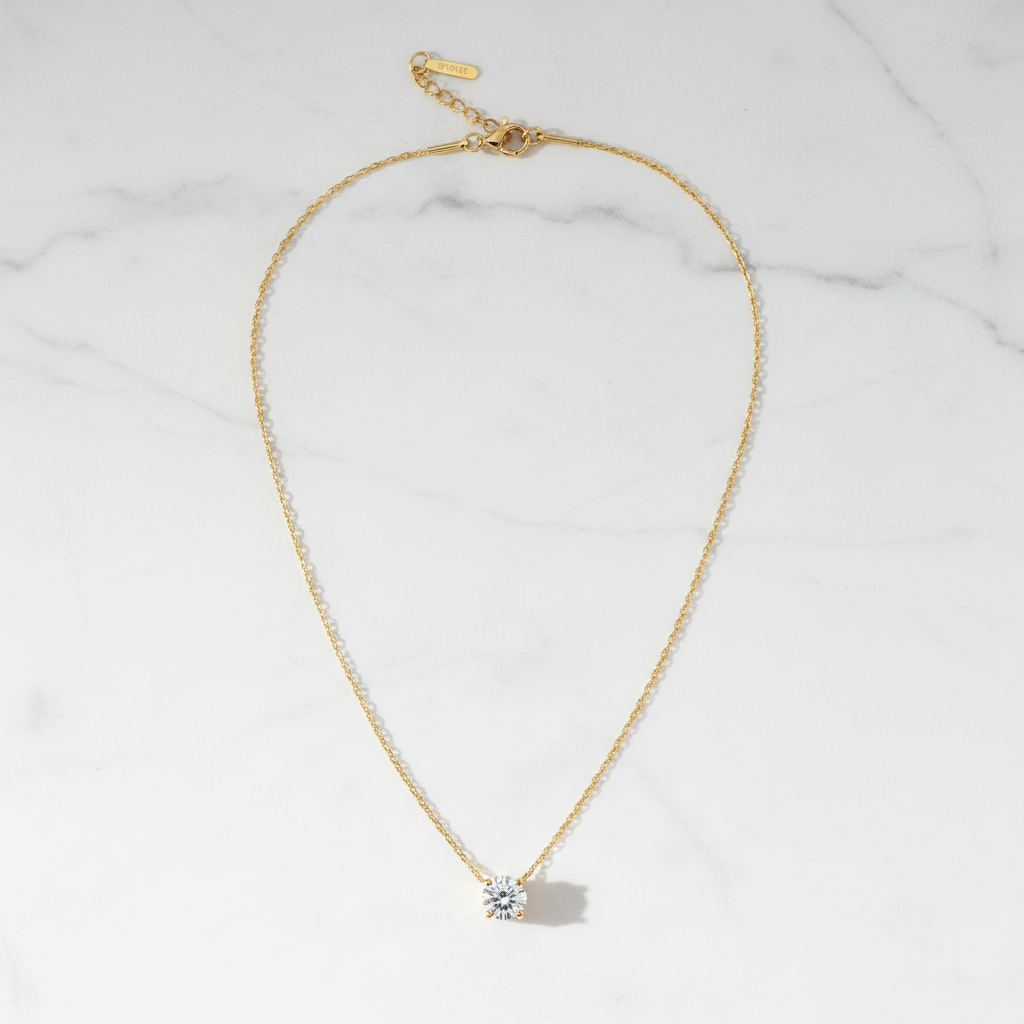St. Lucia diamond solitaire necklace flat lay on white marble