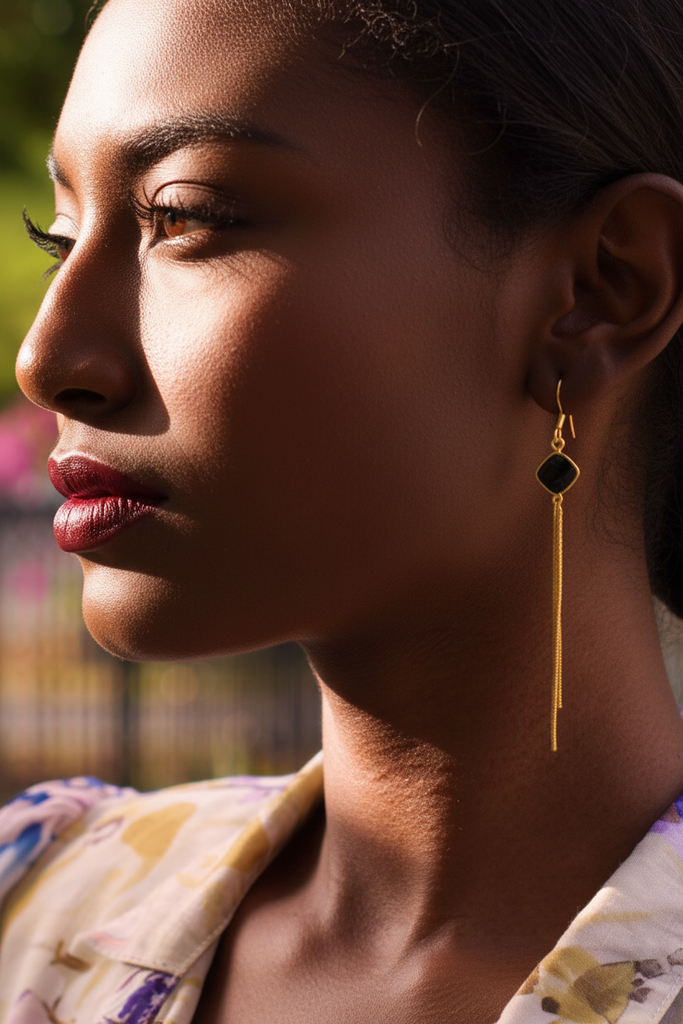 Isabella gold fringe black stone earrings side profile on-ear lifestyle shot