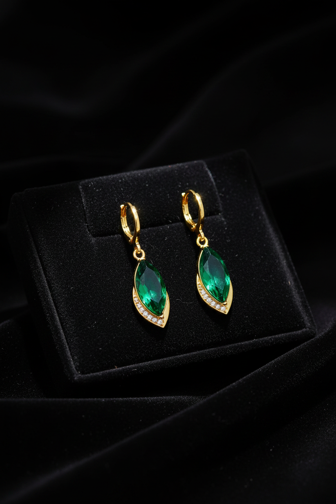 Sawyer emerald drop earrings on dark velvet tray