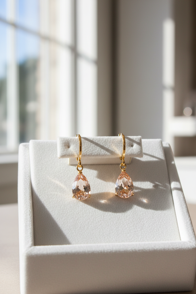 Rory champagne crystal teardrop drop earrings on white velvet tray