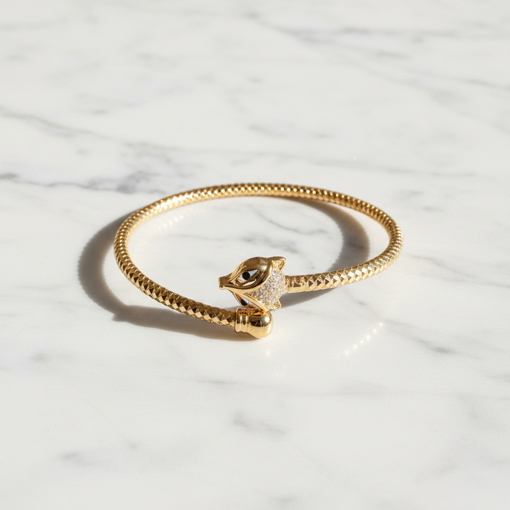 Celeste gold cat head cuff bracelet flat lay on white marble
