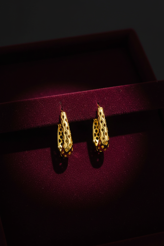Tallulah gold filigree huggie hoop earrings on dark velvet tray
