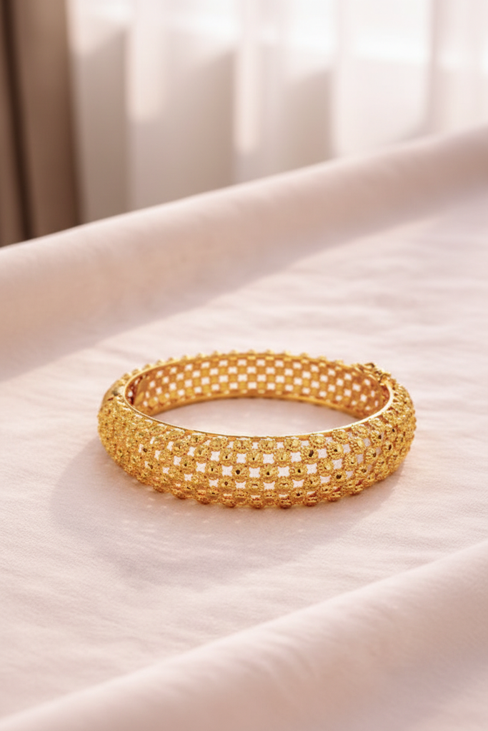 Alessia gold filigree lattice bangle bracelet on cream velvet tray