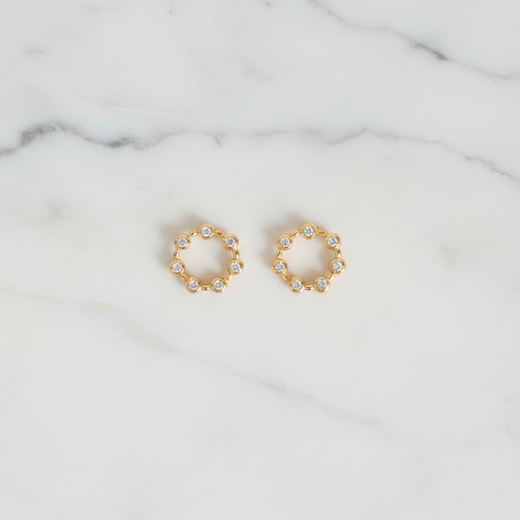 Savannah gold crystal stud earrings flat lay on white marble
