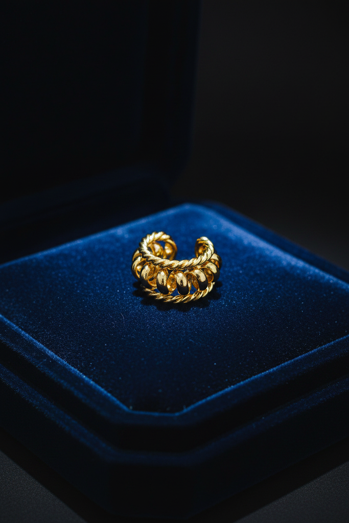 Kai gold multi-strand braided ear cuff on dark velvet tray
