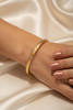 Doha two-tone gold bangle on-wrist single wear
