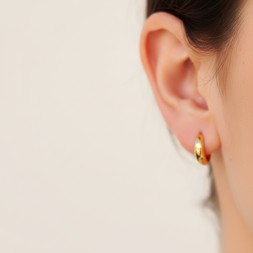 Bailey mini huggie hoop earrings close-up polished detail