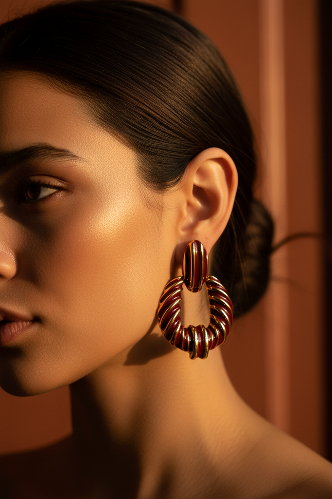 Riley burgundy gold stripe statement earrings on-ear lifestyle shot