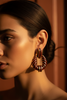Riley burgundy gold stripe statement earrings on-ear lifestyle shot