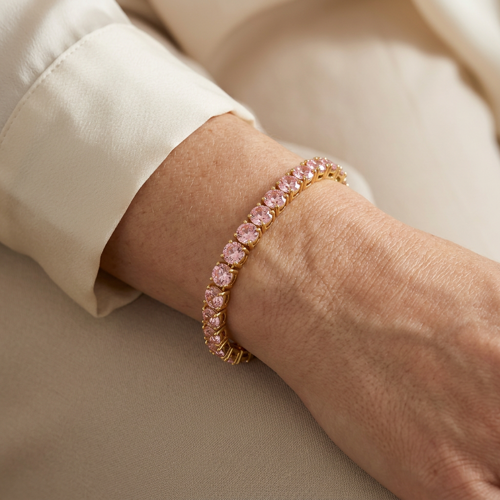 Juliette pink stone tennis bracelet on a model wearing a cream blouse