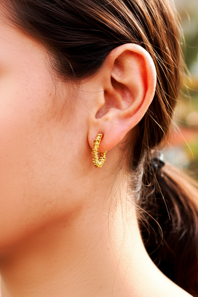 Jaden gold coil wrap spiral hoop earrings on-ear everyday lifestyle shot