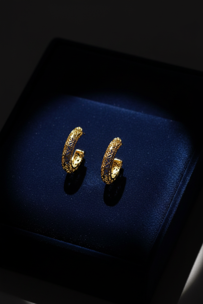 Esi gold plated filigree semi hoop earrings on dark velvet jewelry tray