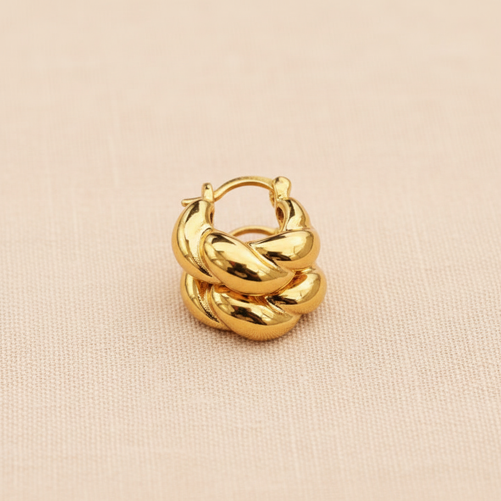 Provence mini twisted gold hoop earrings stacked layering display on peach linen