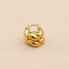 Provence mini twisted gold hoop earrings stacked layering display on peach linen