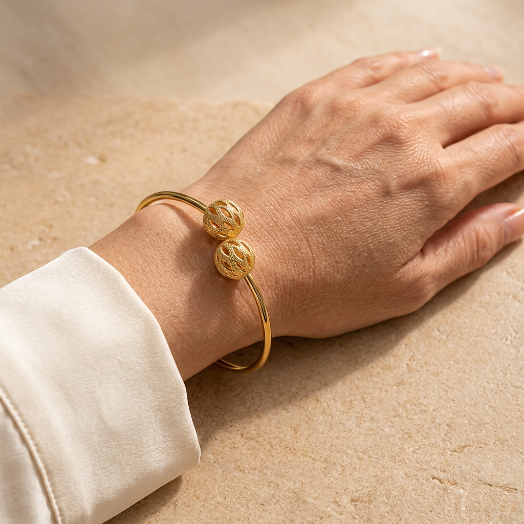 Model wearing the Leighton gold-dipped filigree ball cuff bracelet