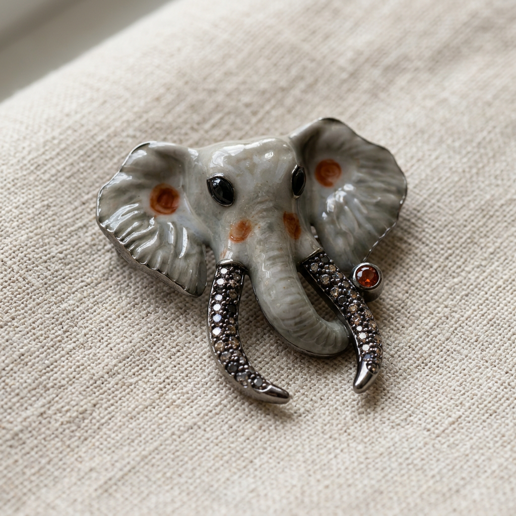 Elegant elephant brooch displayed on beige linen