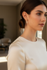 Addison gold diamond drop earrings styled with elegant evening outfit