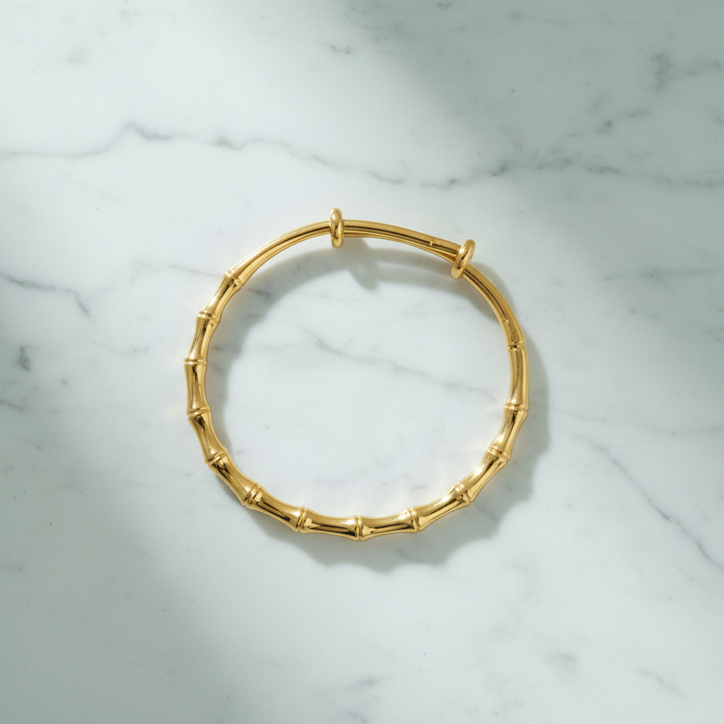 Rome gold bamboo bangle flat lay on white marble