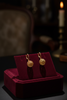 Maddox gold filigree ball drop earrings on dark velvet tray