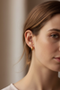 Fionn gold knot hoop earrings on-ear everyday lifestyle shot