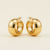 Aponi thick chunky gold hoop earrings close-up wide band detail