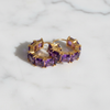 Kennedy purple amethyst stone huggie hoop earrings flat lay on white marble