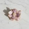 Lavender bloom pearl brooch flat lay on white marble