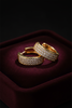 Prague gold pave diamond huggie hoop earrings on dark velvet jewelry tray