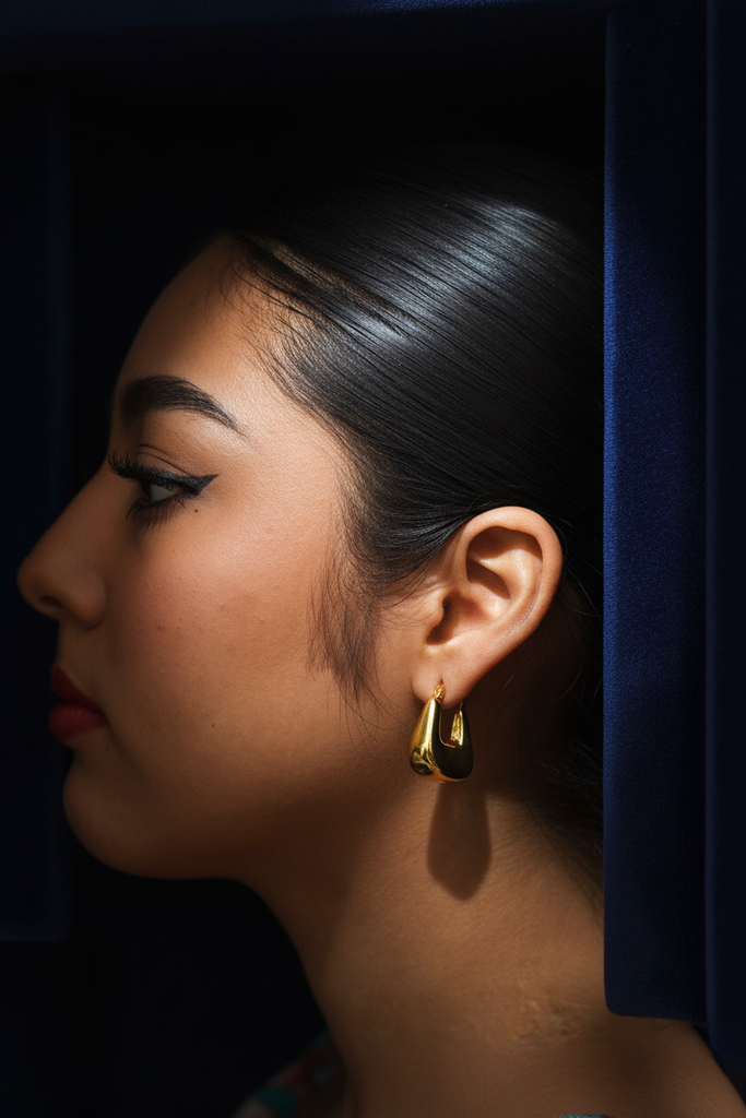 Channing gold square hoop earrings on dark velvet jewelry tray