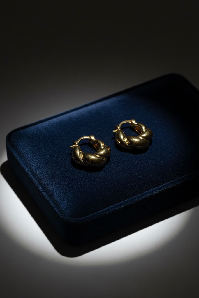 Provence mini twisted gold hoop earrings on dark velvet jewelry tray