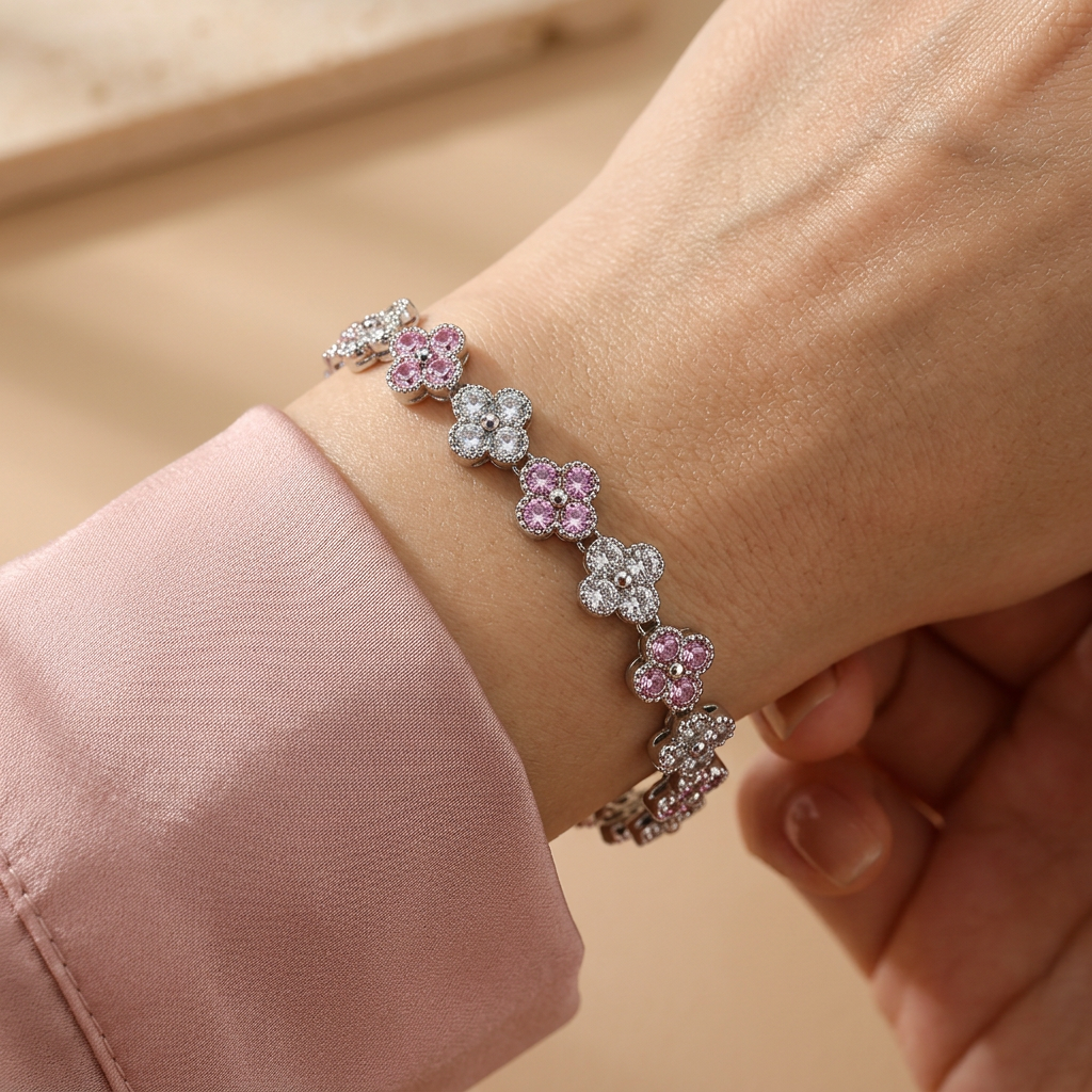 Pink and clear clover bracelet worn on a model's wrist