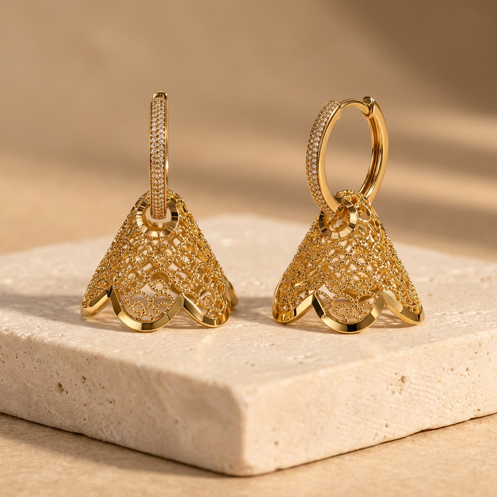 Prescott gold-tone dangle earrings on a cream stone pedestal