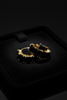 Kennedy black stone huggie hoop earrings on dark velvet tray