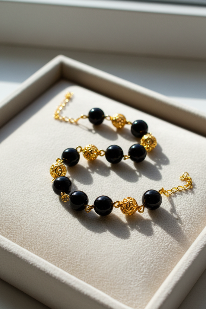 Elizabeth black resin and gold filigree ball bracelet cream velvet tray display