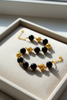 Elizabeth black resin and gold filigree ball bracelet cream velvet tray display