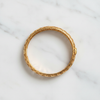 Riviera gold floral filigree bangle flat lay on white marble