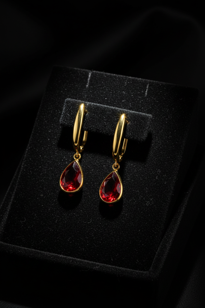 Amelia ruby red stone drop earrings on dark velvet tray