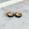 Kennedy black stone huggie hoop earrings flat lay on white marble