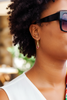 Catori gold plated ruby dangle earrings on-ear lifestyle editorial shot