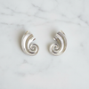 Kilgory silver swirl statement earrings flat lay on white marble