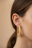 Quinn gold filigree caged hoop earrings side profile close-up on ear