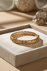 Riviera gold floral filigree bangle cream velvet tray display