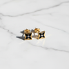 Lisbon gold and black star motif stud earrings flat lay on white marble